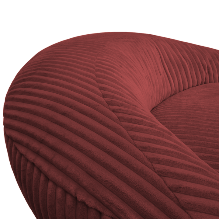 Gros plan sur le dossier arrondi du pouf XXL, tissu en velours côtelé.