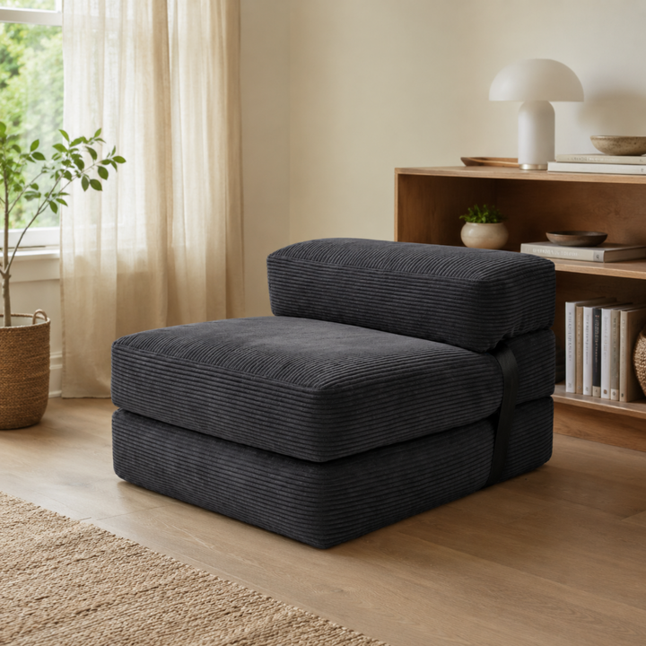 Chauffeuse pliable gris foncé avec assise large et dossier rembourré en tissu côtelé