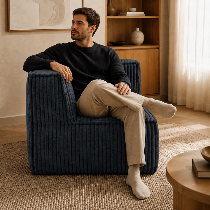 Personne assise sur le lodule d’angle en velours côtelé dans un salon